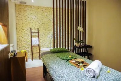 a bedroom with a bed with a tray of food on it at FuramaXclusive Ocean Beach Seminyak Bali in Legian