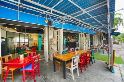 a restaurant with red tables and chairs at FuramaXclusive Ocean Beach Seminyak Bali in Legian