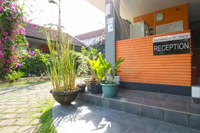 a row of potted plants sitting outside of a hotel at Sayang Residence 2 in Denpasar