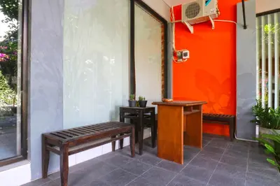 a porch with a bench and a basketball hoop at Sayang Residence 2 in Denpasar