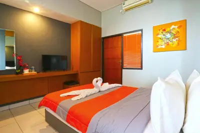 a bedroom with a bed with towel animals on it at Sayang Residence 2 in Denpasar