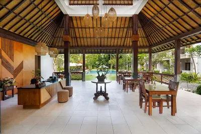 a pavilion with tables and chairs and a dining area at Kusuma Resort Seminyak in Seminyak