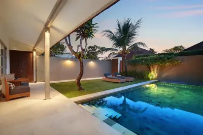 a swimming pool in the backyard of a villa at Uma Sapna Seminyak in Seminyak
