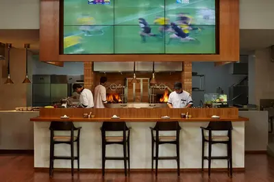 a group of chefs preparing food in a kitchen at Aryaduta Bali in Kuta