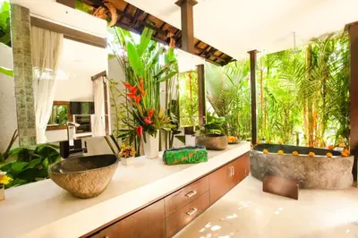 a bathroom with a sink and some plants at Villa Besok in Seminyak