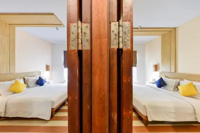 two beds in a room with two beds sidx sidx sidx sidx at The ONE Legian in Legian