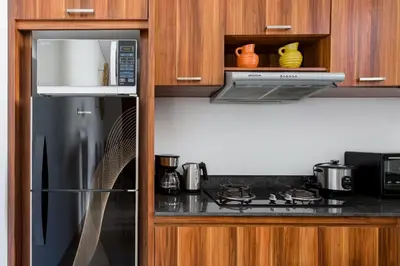 a kitchen with a refrigerator and a microwave at Villa Manis La Bora in Seminyak in Seminyak