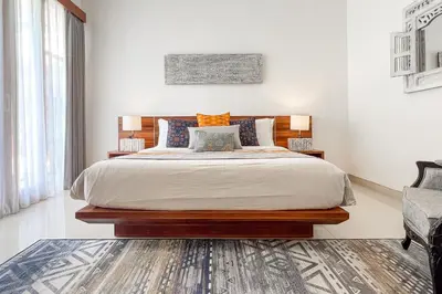 a bedroom with a large bed and two lamps at Villa Manis La Bora in Seminyak in Seminyak
