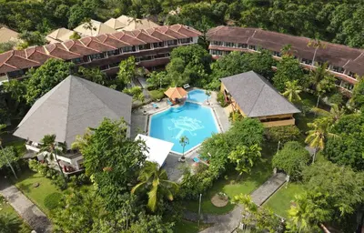 an aerial view of a resort with a swimming pool at Palm Beach Hotel Bali in Kuta