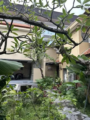 a house with a garden in front of it at Villa Bunga Hotel in Seminyak