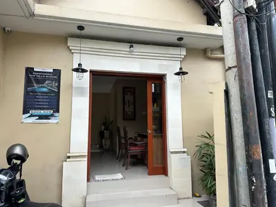 a entrance to a building with a table in it at Villa Bunga Hotel in Seminyak