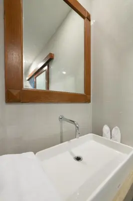 a bathroom with a sink and a mirror at Villa Bunga Hotel in Seminyak