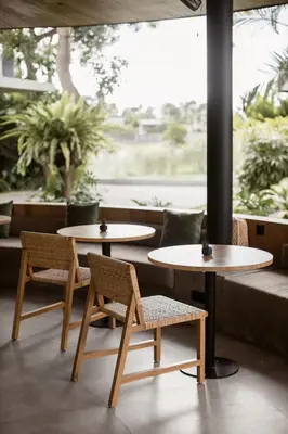 two tables and chairs in front of a window at Wave House Resort Canggu in Canggu