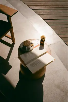 a book and a watch sitting on a table at Wave House Resort Canggu in Canggu