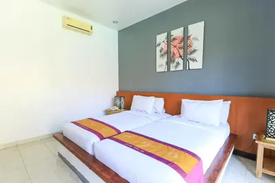 a bedroom with a large white bed in it at Bali Merita Villa in Canggu