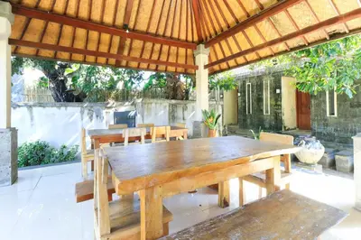a wooden table and chairs under a pavilion at Bali Merita Villa in Canggu