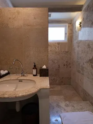 a bathroom with a sink and a shower at Kresna By The Sea By Kresna Hospitality in Seminyak