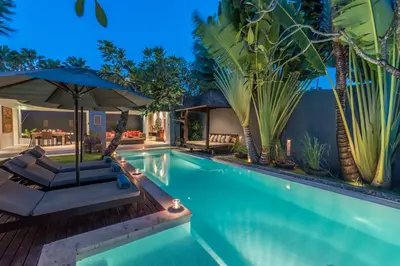 an image of a swimming pool with a villa at Kembali Villas in Seminyak