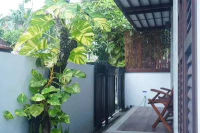 a porch with a gate and a plant at Dim House Jimbaran in Jimbaran
