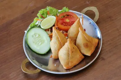 a plate of food with pita sandwiches and a salad at Kupu Kupu Jimbaran Beach Hotel & Spa by L’Occitane in Jimbaran