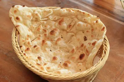 a tortilla sitting in a basket on a table at Kupu Kupu Jimbaran Beach Hotel & Spa by L’Occitane in Jimbaran