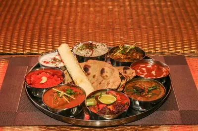 a plate of food with different types of food on a table at Kupu Kupu Jimbaran Beach Hotel & Spa by L’Occitane in Jimbaran