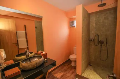 a bathroom with a sink and a toilet and a shower at Kupu Kupu Jimbaran Beach Hotel & Spa by L’Occitane in Jimbaran
