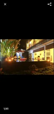a picture of a house at night with lights at Degung de brata Family villas in Legian