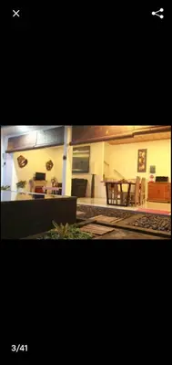 a living room with a table and a dining room at Degung de brata Family villas in Legian