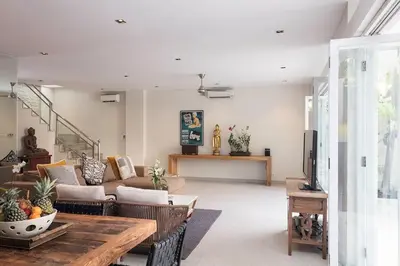 a living room with a couch and a table at Villa Bebek in Seminyak