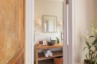 a bathroom with a sink and a mirror at Villa Bebek in Seminyak