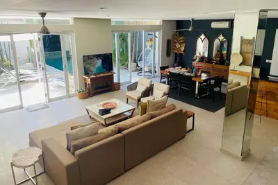 a living room with a couch and a table at Villa Bebek in Seminyak