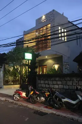 a couple of motorcycles parked in front of a building at Green Studio Apartment Seminyak in Seminyak