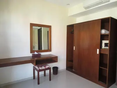a bathroom with a wooden vanity and a mirror at Seminyak TownHouse in Legian