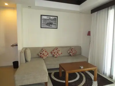 a living room with a couch and a table at Seminyak TownHouse in Legian
