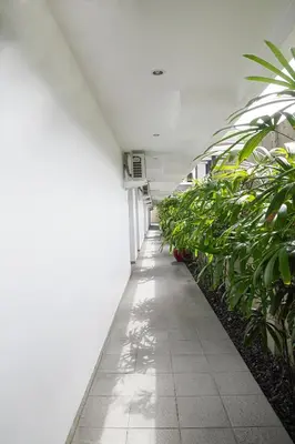 a hallway of an office building with plants at Seminyak TownHouse in Legian