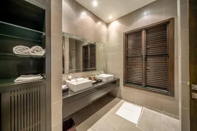 a bathroom with two sinks and a mirror at The Town House in Seminyak