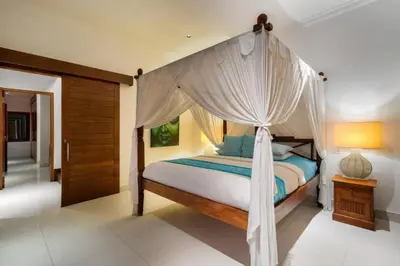 a bedroom with a canopy bed in a room at Super Value 3 Bed, Central Seminyak, Walk to Beach in Seminyak