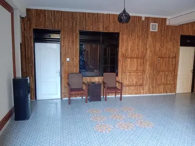 a room with two chairs and a table and a rug at City Garden Bali Dwipa Hotel, Kuta in Kuta