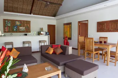 a living room with a couch and a table at Villa Kakariki in Kerobokan