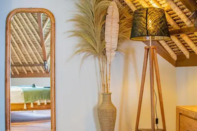 a floor lamp and a mirror in a room at SuB Villas Bali in Canggu
