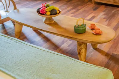 a wooden table with a bowl of fruit on it at SuB Villas Bali in Canggu