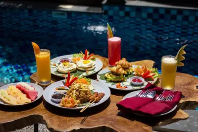 a table topped with plates of food and drinks at Mokko Suite Villas Umalas Bali in Seminyak
