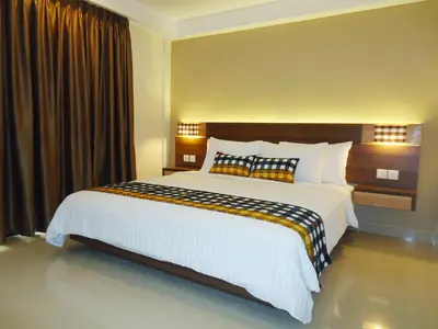 a bedroom with a large bed in a hotel at Grand Barong Resort in Kuta