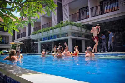 a group of people in the swimming pool at a hotel at Grand Barong Resort in Kuta