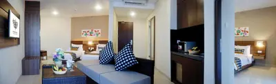 two views of a living room and a hotel room at Grand Barong Resort in Kuta