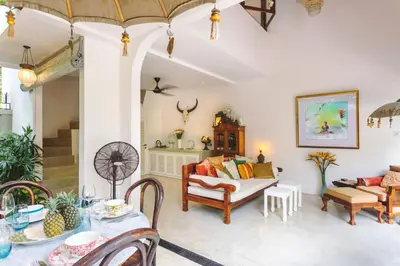 a living room with a couch and a table at Villa Vickary Seminyak in Seminyak