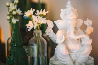 a white statue sitting next to some glass bottles at Villa Vickary Seminyak in Seminyak
