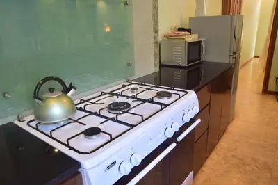 a tea kettle sitting on a stove in a kitchen at Villa Putu Mira By Maha Bali in Kuta