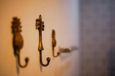 a door with two handles on a white door at The Kubu Hotel in Kuta